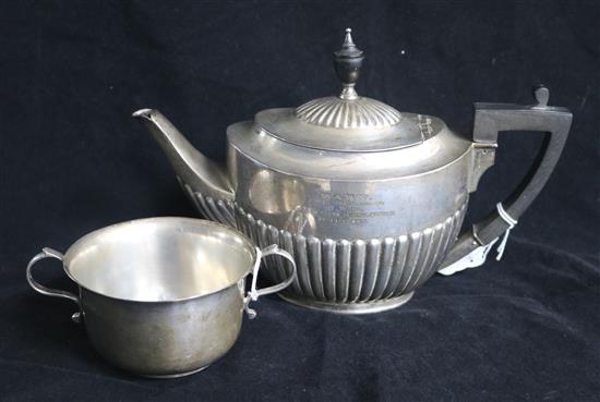 An Edwardian demi fluted silver oval teapot by William Hutton & Sons, London, 1907 and a silver porringer, gross 20.5 oz.